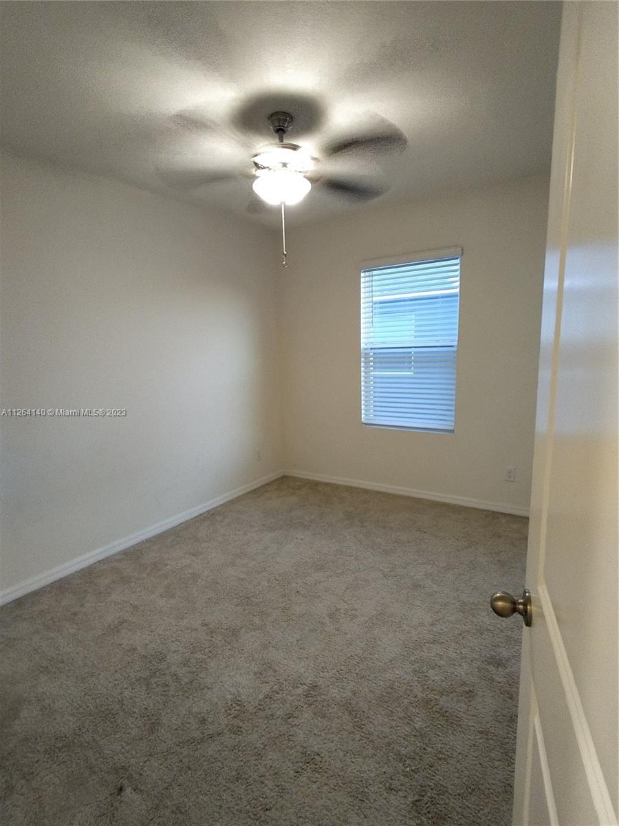 8749 Falling Blue Place Riverview, FL 33578 - Photo 25 of 51 an empty room with a chandelier fan