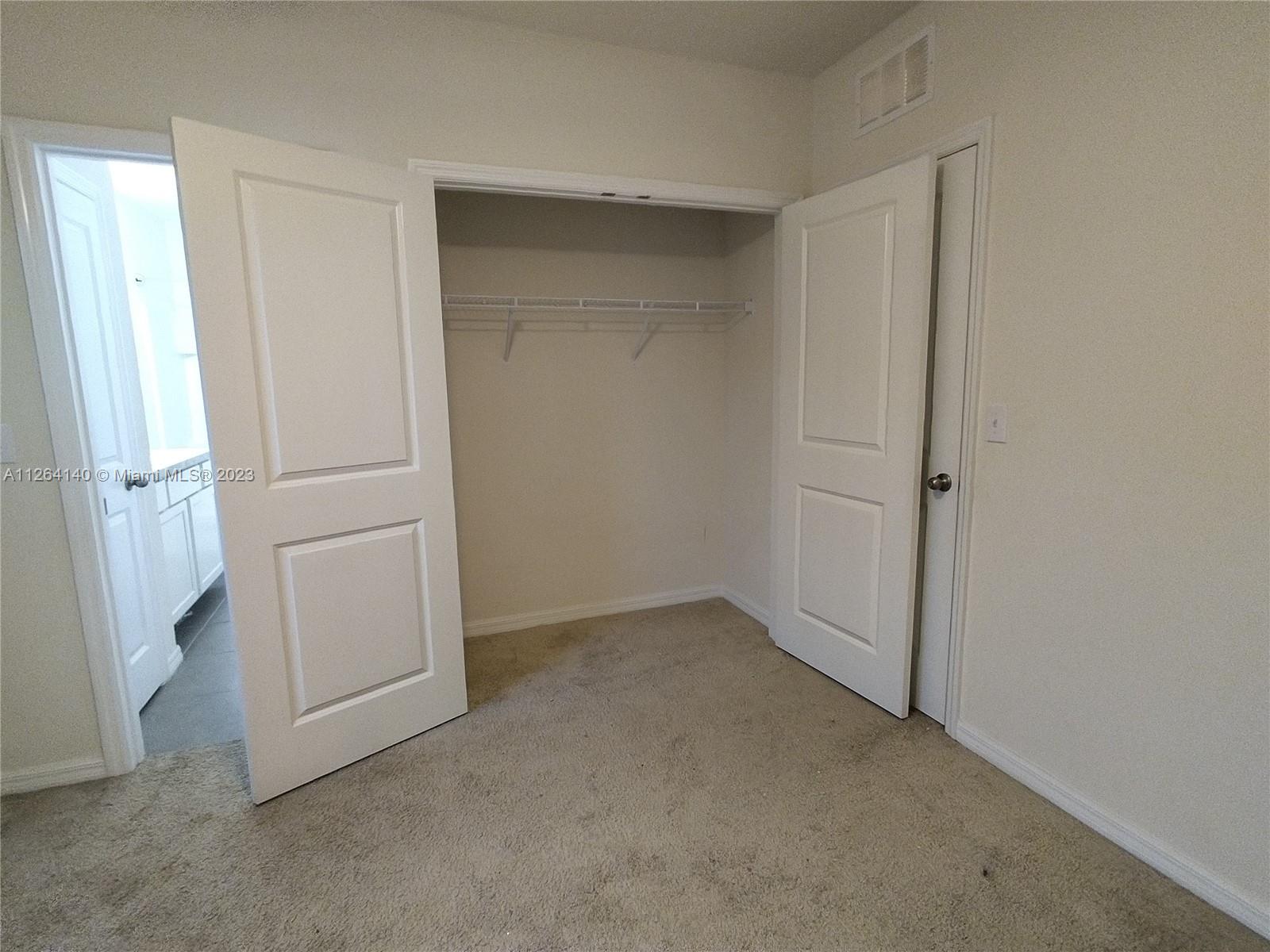 8749 Falling Blue Place Riverview, FL 33578 - Photo 26 of 51 an empty room with white door and cabinet