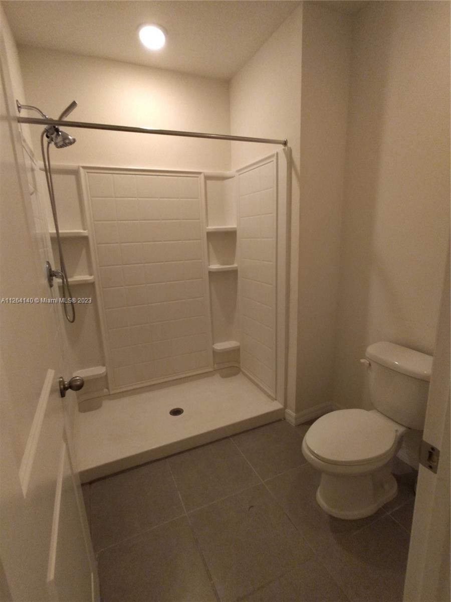 8749 Falling Blue Place Riverview, FL 33578 - Photo 34 of 51 a bathroom with a toilet and a shower