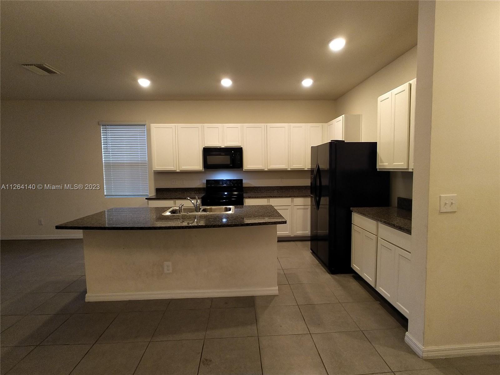 8749 Falling Blue Place Riverview, FL 33578 - Photo 8 of 51 a kitchen with a refrigerator and a stove