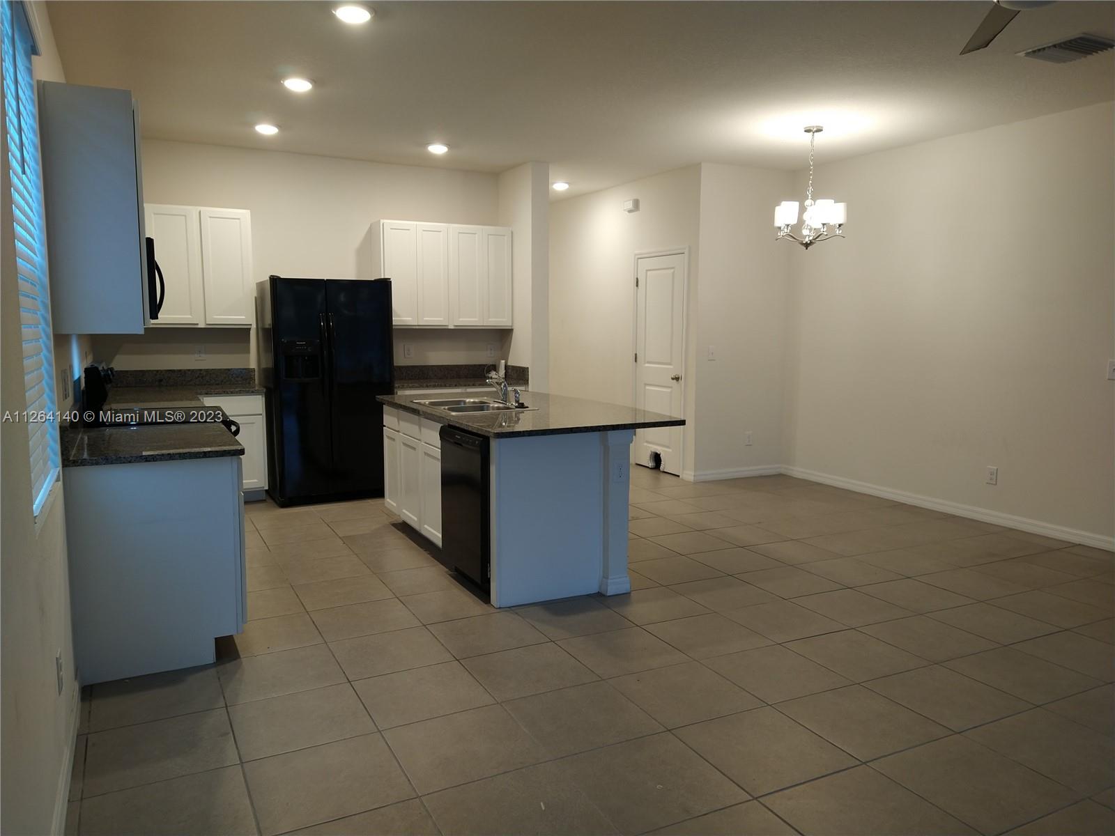 8749 Falling Blue Place Riverview, FL 33578 - Photo 9 of 51 a kitchen with stainless steel appliances granite countertop a refrigerator a stove and a sink