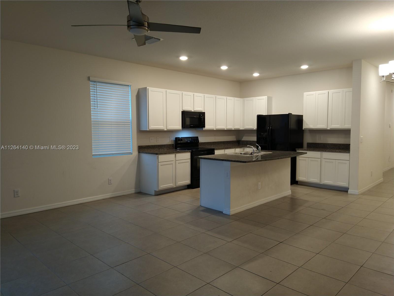 8749 Falling Blue Place Riverview, FL 33578 - Photo 10 of 51 a kitchen with stainless steel appliances granite countertop a stove top oven a sink and a refrigerator