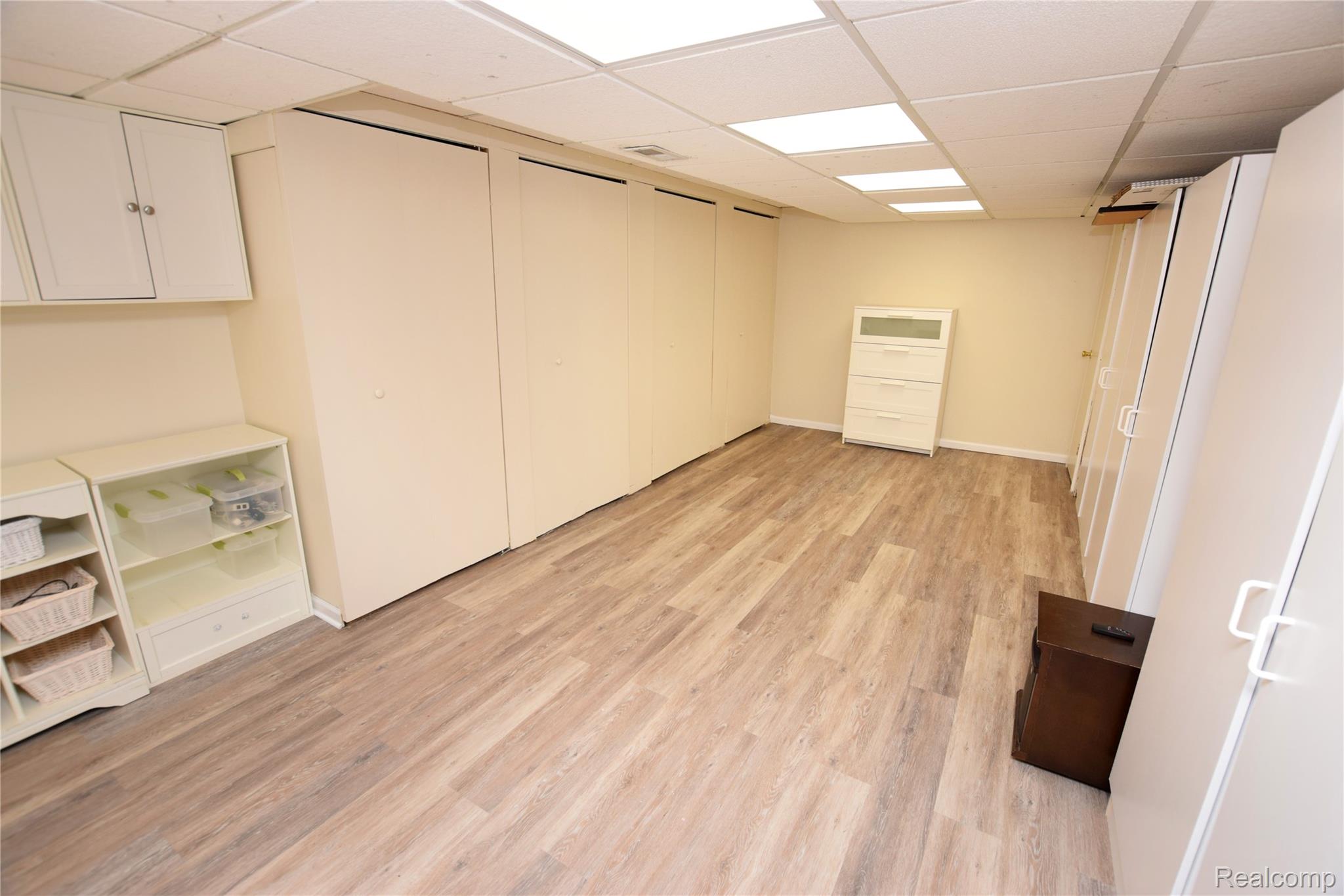 15489 Linden Road Linden, MI 48451 - Photo 21 of 25 Finished basement featuring light wood-type flooring and a drop ceiling