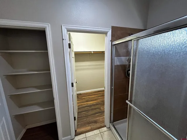 a view of walk in closet with empty racks