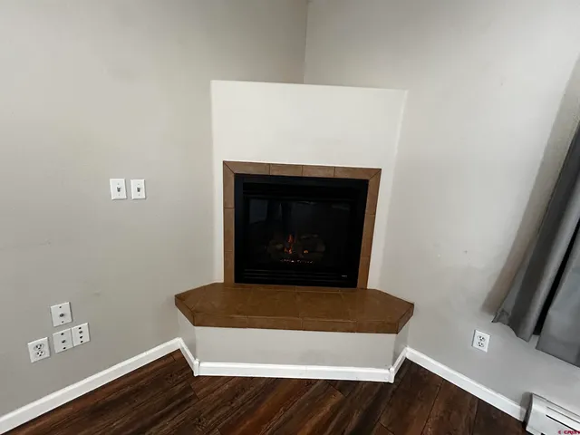 a view of fireplace and wooden floor