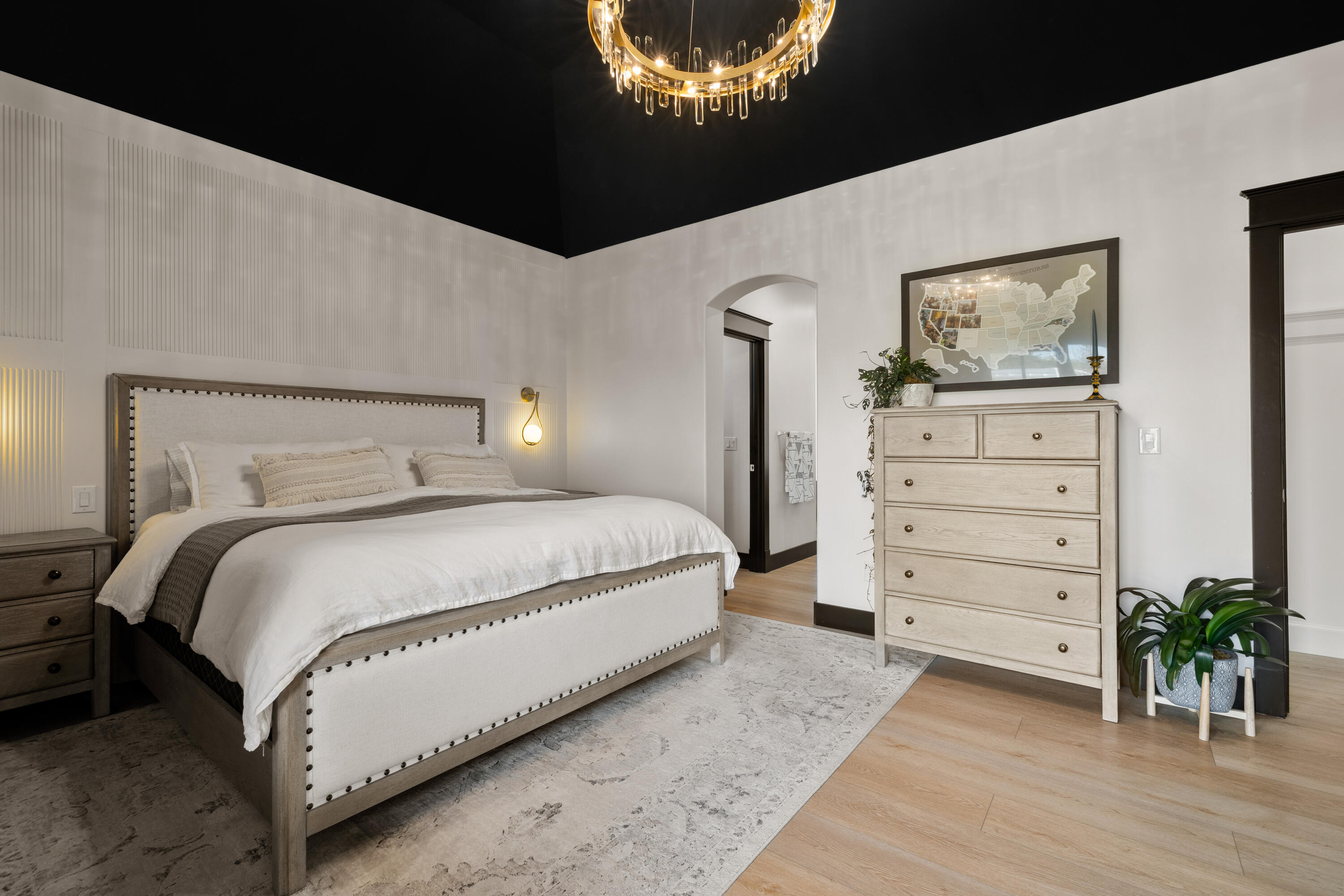 62705 Hamby Road Bend, OR 97701 - Photo 16 of 49 a bedroom with a bed and a chandelier