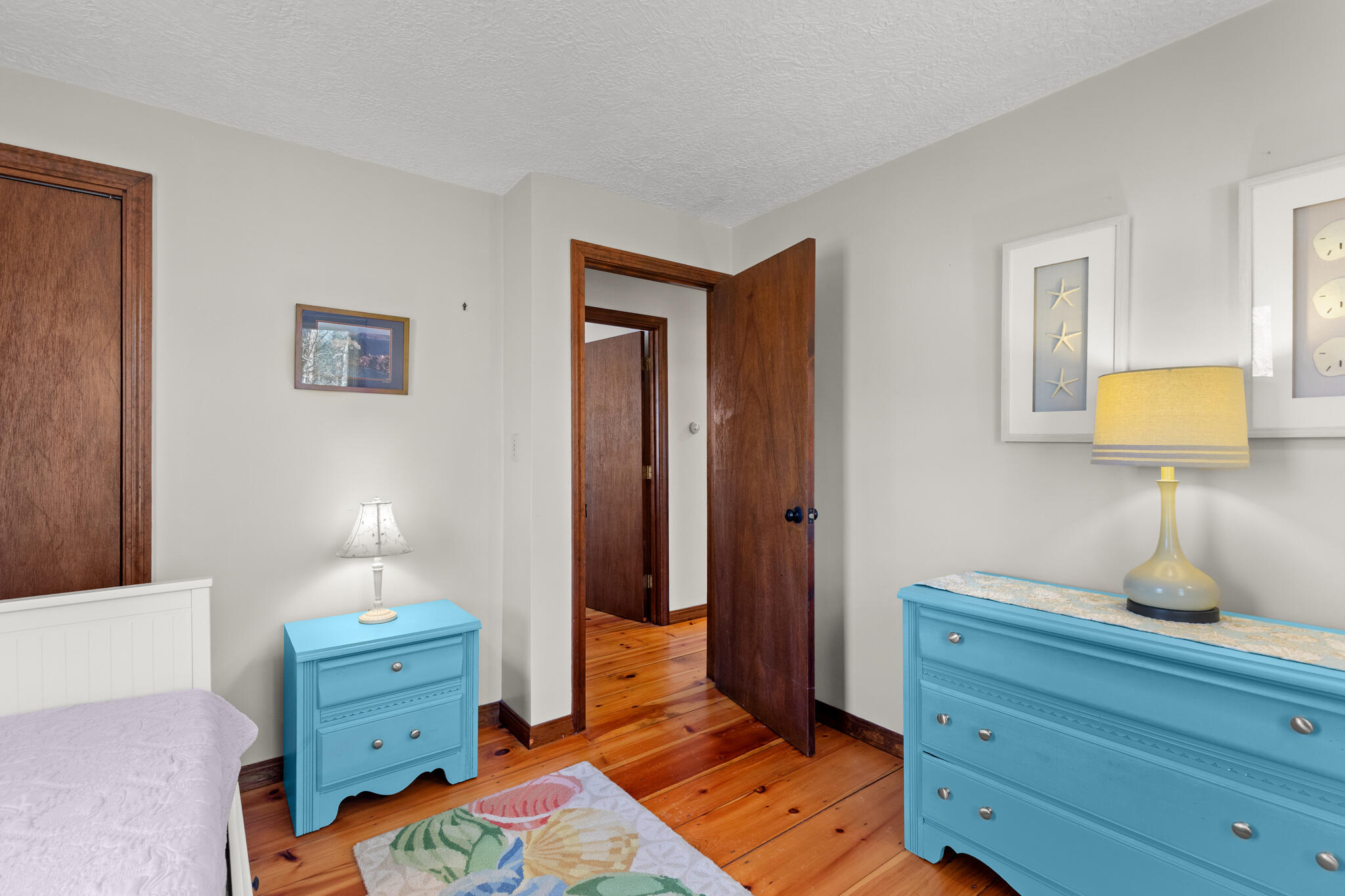 20 Stone Court Eastham, MA 02642 - Photo 16 of 31 a bedroom with a bed and wooden floor