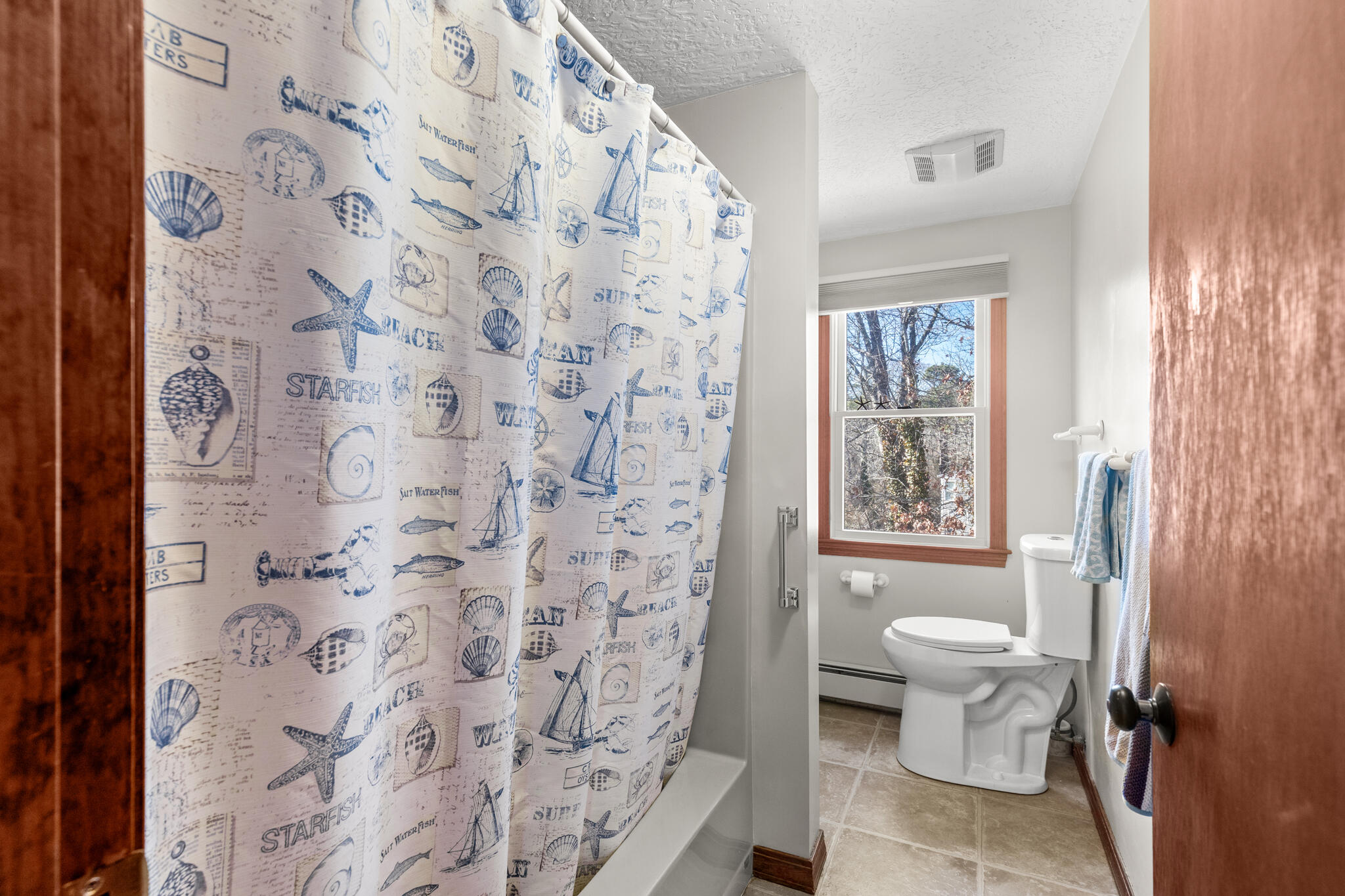 20 Stone Court Eastham, MA 02642 - Photo 19 of 31 a bathroom with a toilet and a shower curtain