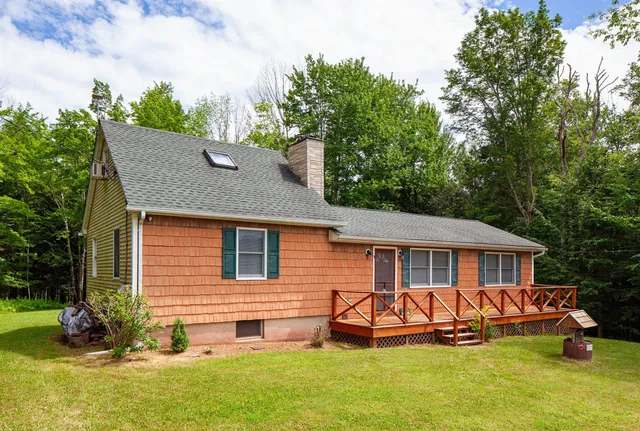 a front view of a house with a yard table and chairs