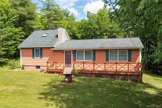 a view of an house with backyard space and sitting area