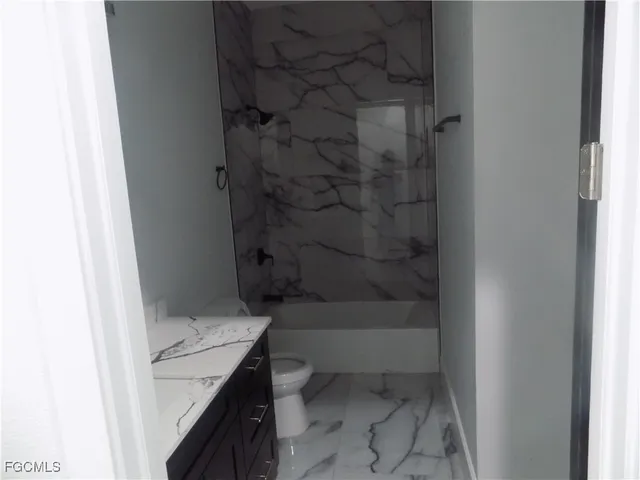 a view of a backyard with plants and large trees