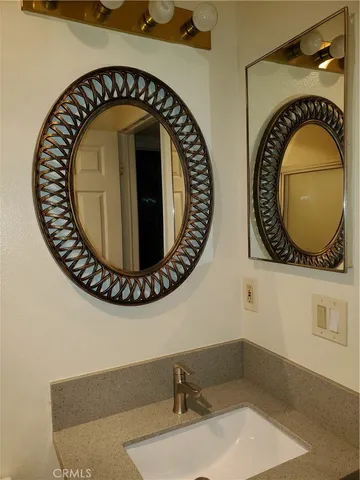 with a bathroom with a sink mirror and vanity