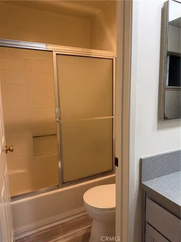 a bathroom with a shower and a toilet
