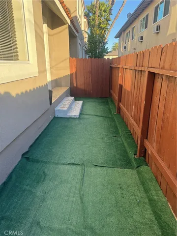 a view of a backyard with wooden fence