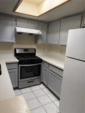 a kitchen with a stove and a refrigerator