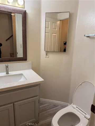 a bathroom with a sink a toilet and mirror