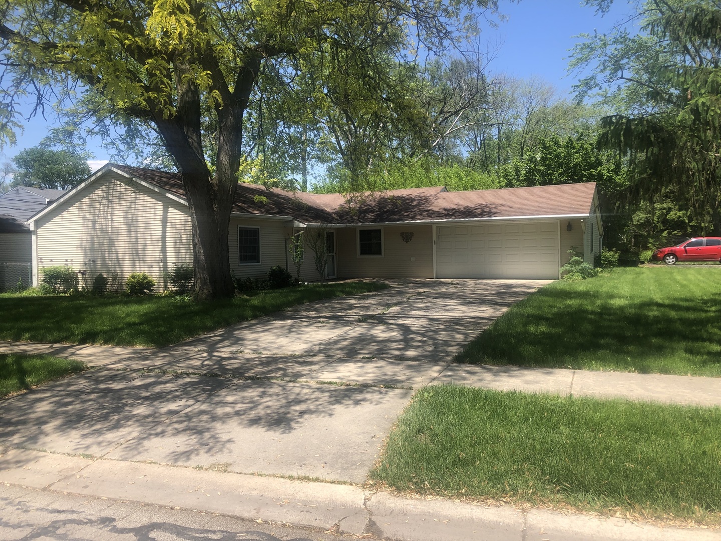 a front view of house with yard and green space