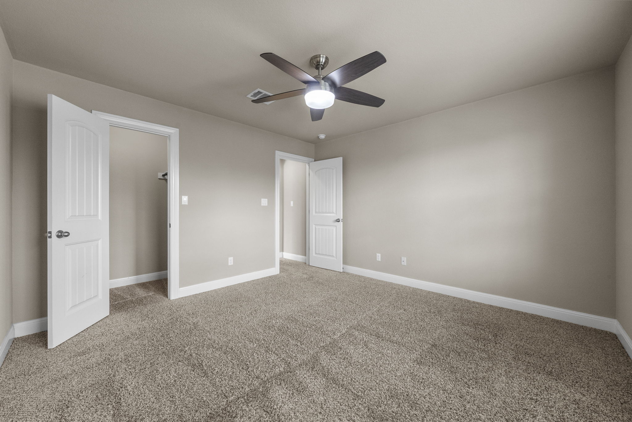 4401 Trinity Woods Street Leander, TX 78641 - Photo 8 of 37 A quiet retreat with a cozy atmosphere, this bedroom features soft carpeting and a modern ceiling fan.