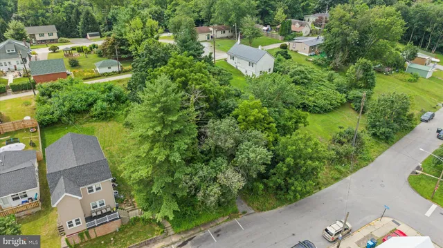an aerial view of a house with garden space and street view