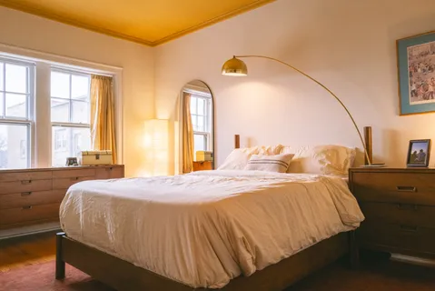 a bedroom with a bed and a window