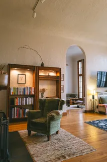 a living room with furniture and a wooden floor