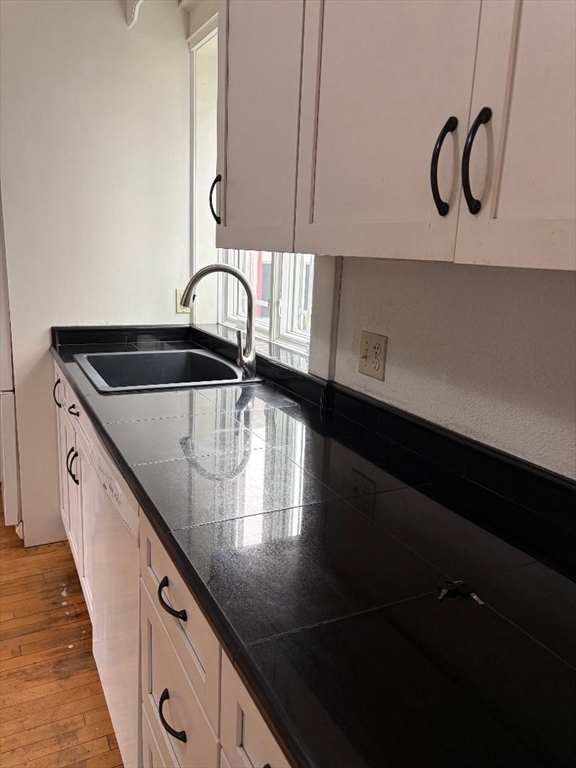 19 Wellesley Road Holyoke, MA 01040 - Photo 6 of 27 a kitchen with kitchen island a sink a stove and cabinets