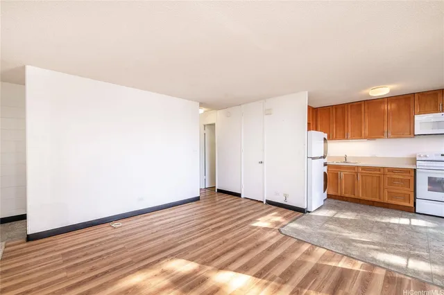a view of a kitchen with wooden floor