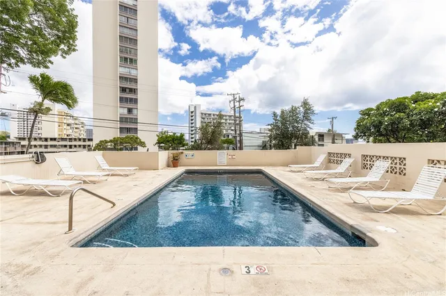 a view of a swimming pool with a lounge chairs