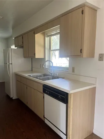 a kitchen with stainless steel appliances a sink stove and cabinets