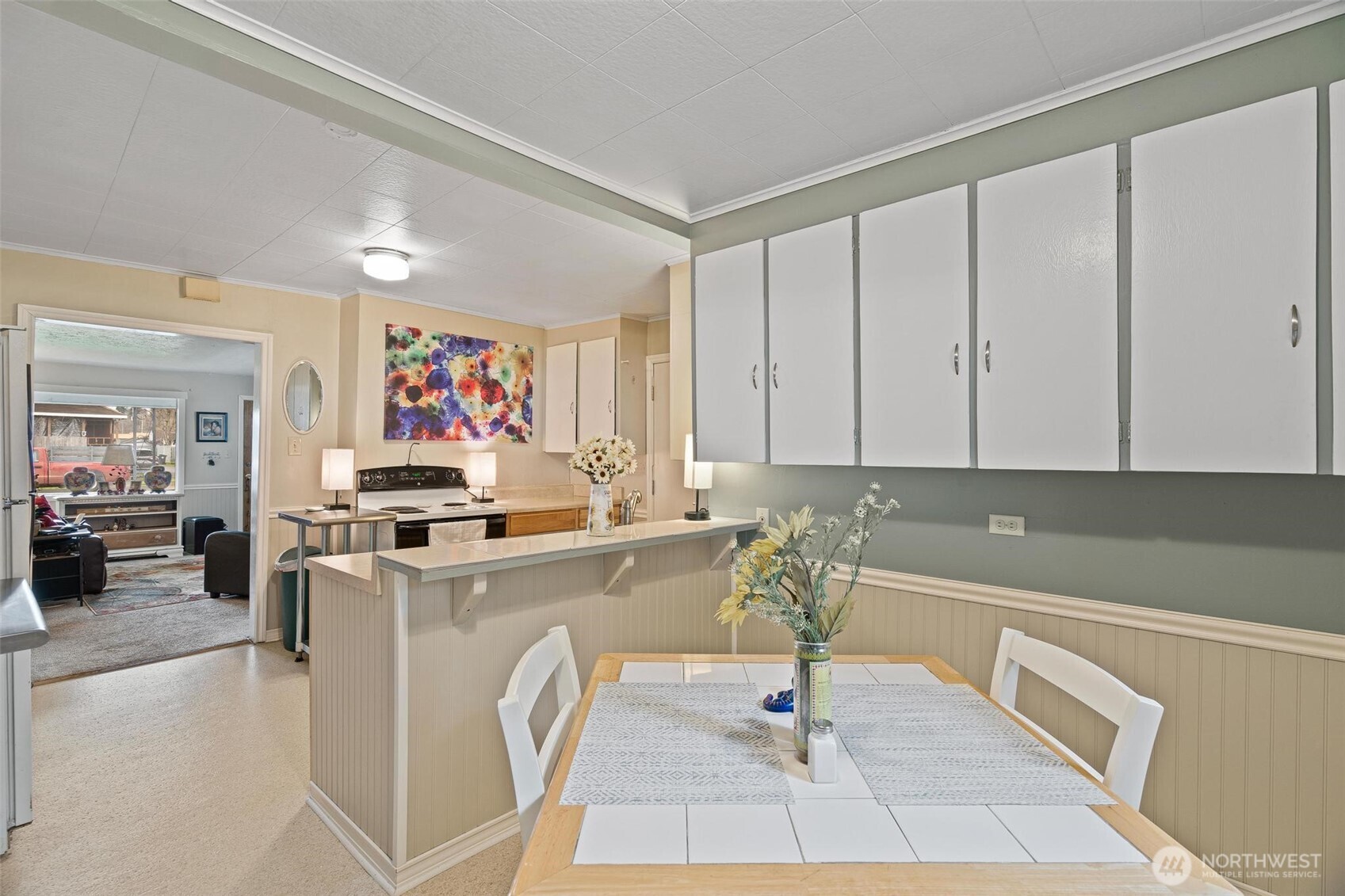 211 30th Street Hoquiam, WA 98550 - Photo 11 of 24 a living room with stainless steel appliances furniture a rug and a kitchen view