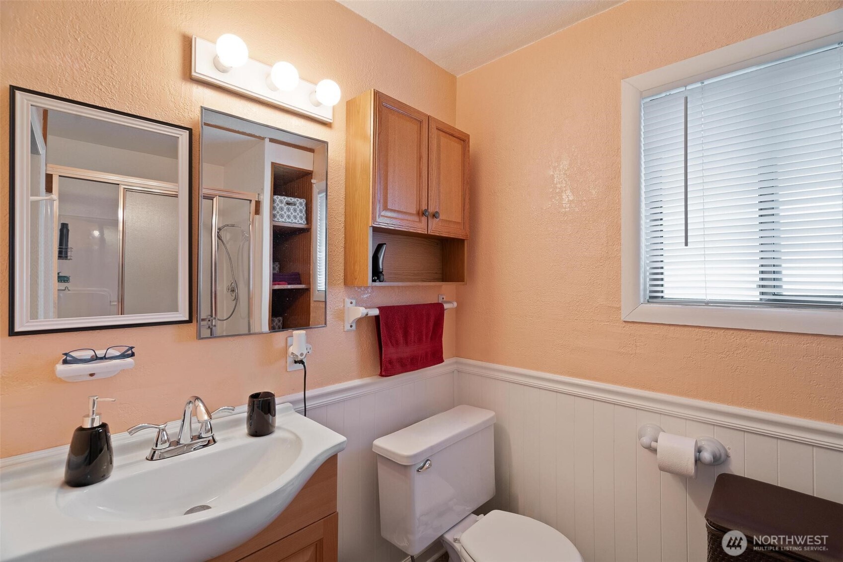 211 30th Street Hoquiam, WA 98550 - Photo 15 of 24 a bathroom with a toilet sink a mirror and window