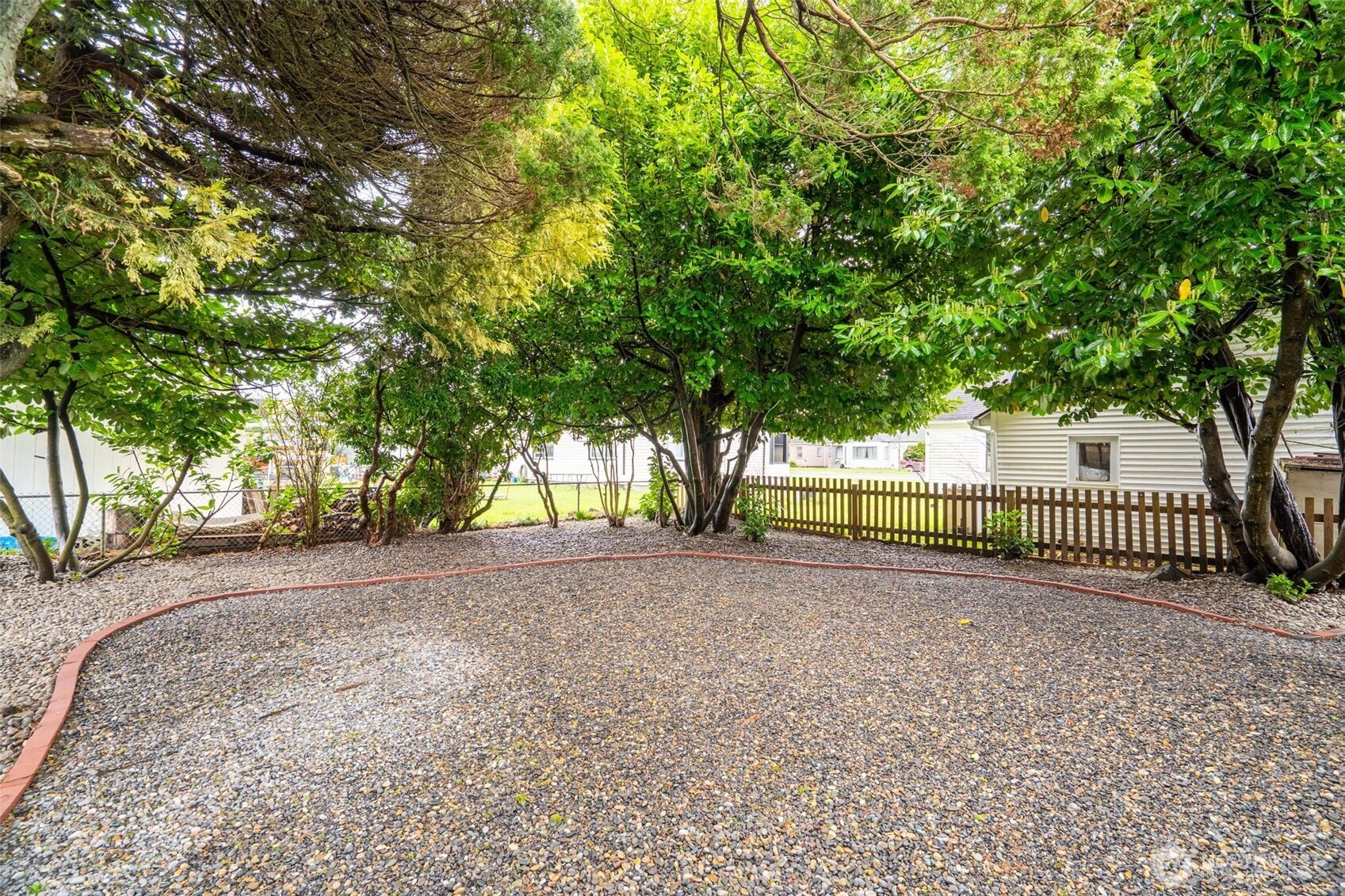 211 30th Street Hoquiam, WA 98550 - Photo 21 of 24 a view of a garden with trees in front of house