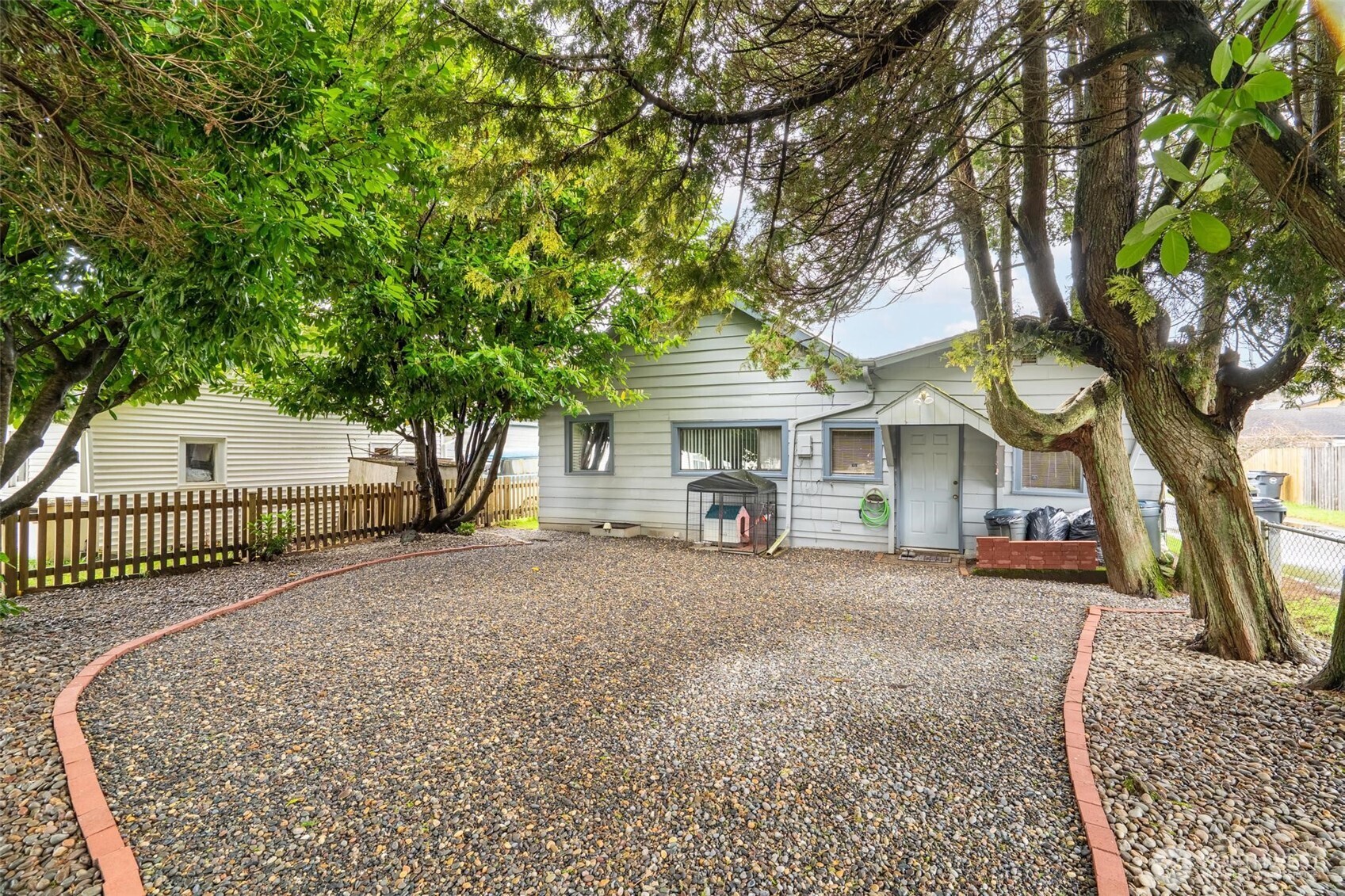 211 30th Street Hoquiam, WA 98550 - Photo 22 of 24 a front view of a house with a garden and trees