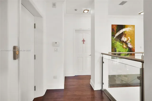 a view of a living room with a wooden floor and wall