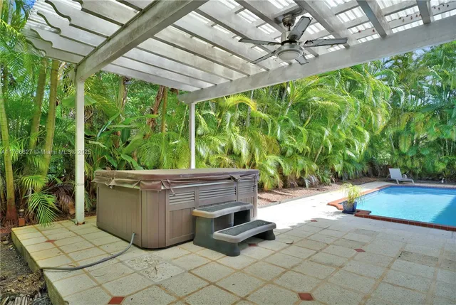 a view of patio with a chairs and plants