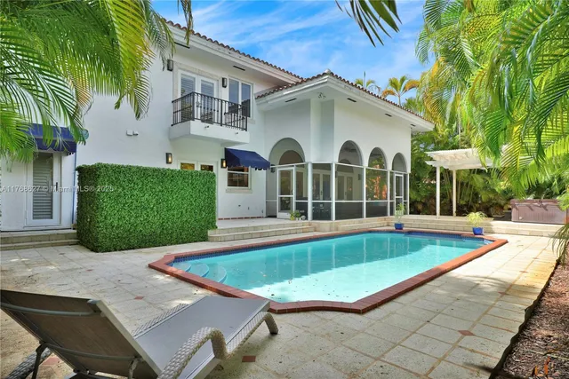 a view of a house with a swimming pool and a chairs