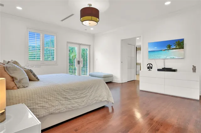 a bedroom with a bed and a large window