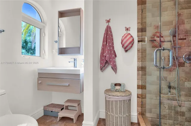 a bathroom with a toilet and a shower curtain