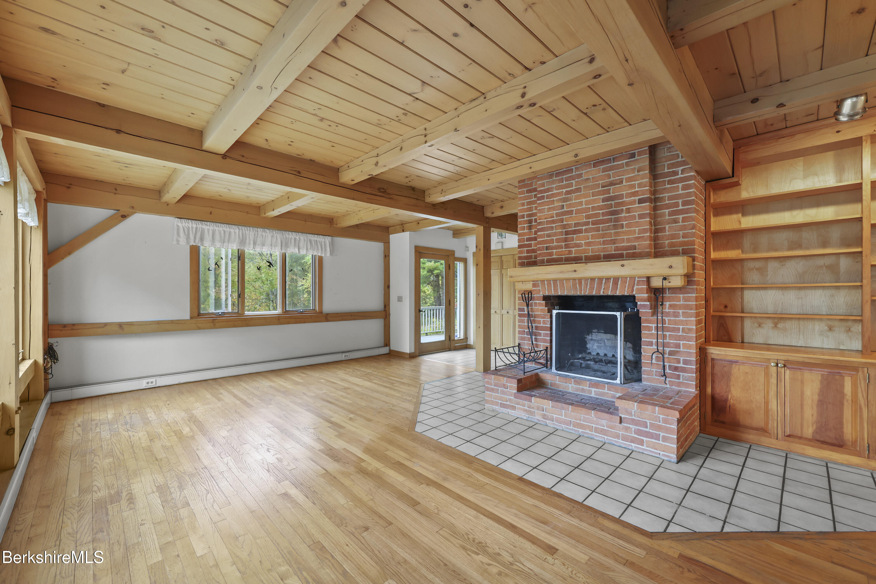 1030 Simonds Road Williamstown, MA 01267 - Photo 7 of 76 a view of an empty room with a fireplace and a window