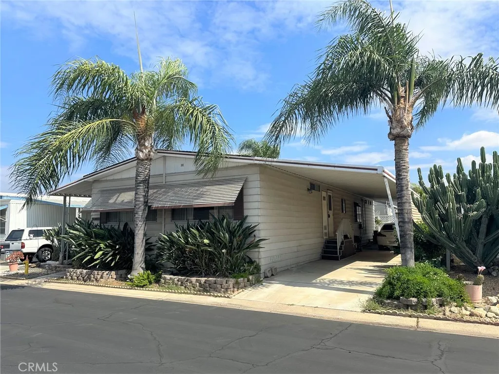 4000 Pierce Street, Unit 260 Riverside, CA 92505 - Photo 1 of 1 a view of a house with a yard and palm trees