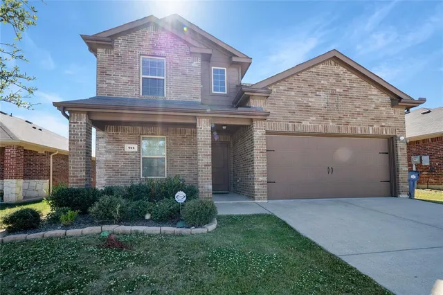 a front view of a house with a garden and plants