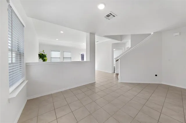 an empty room with windows and entrance