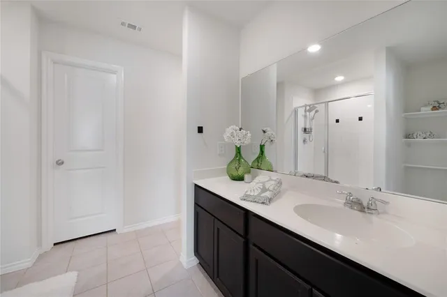 a bathroom with a glass shower door and a glass door