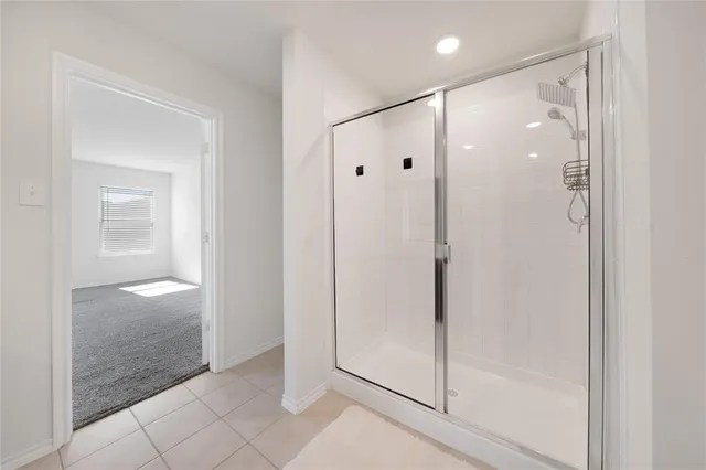 a spacious bathroom with a toilet a sink and a mirror