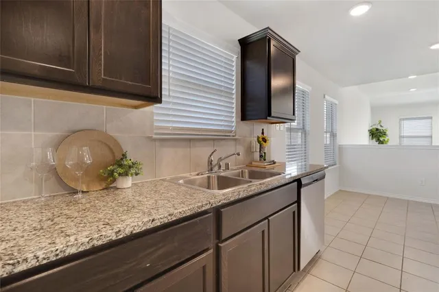 a kitchen with stainless steel appliances granite countertop a stove a microwave and a sink