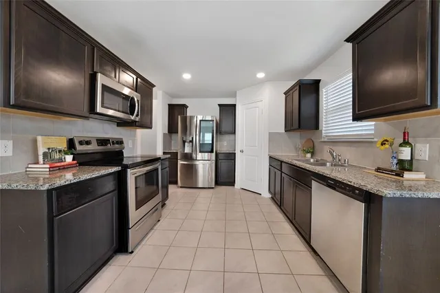 a view of kitchen with furniture and refrigerator