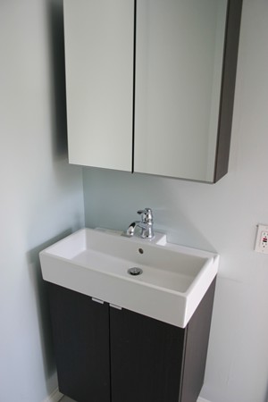 526 Centre Street, Unit 3 Boston, MA 02130 - Photo 13 of 15 a white sink sitting under a bathroom mirror