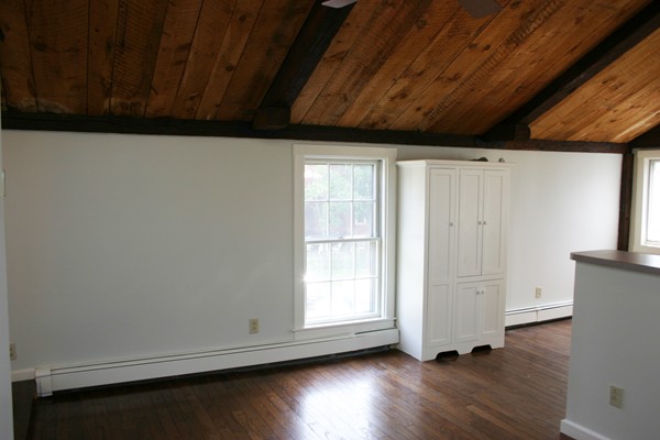 526 Centre Street, Unit 3 Boston, MA 02130 - Photo 4 of 15 a view of empty room with wooden floor and fan