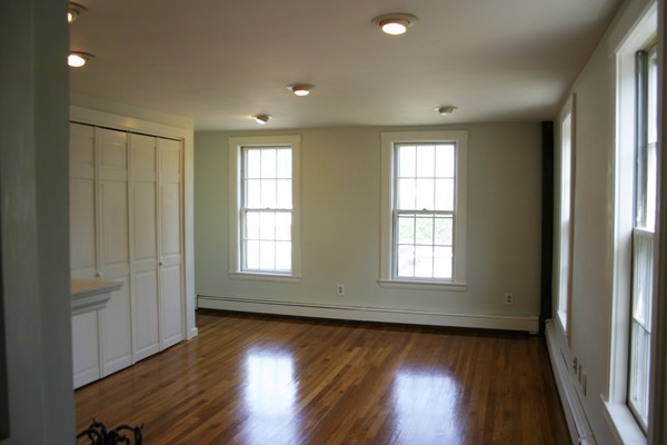 526 Centre Street, Unit 3 Boston, MA 02130 - Photo 10 of 15 a view of an empty room with wooden floor and a window
