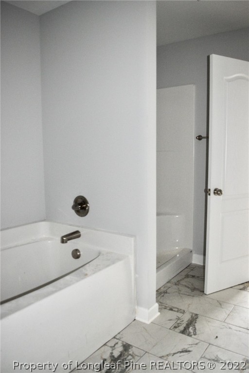 263 McMillan Siding Road Parkton, NC 28371 - Photo 11 of 15 a bathroom with a tub and a shower